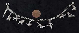 Charms include 2 dogs, a covered wagon, a teapot, an elephant, a 