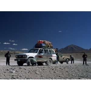  and Tourists on Jeep Tour Taking a Break on Uyuni Salt Flat 