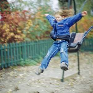  A Girl Jumping from a Swing in a Playground Photographic 