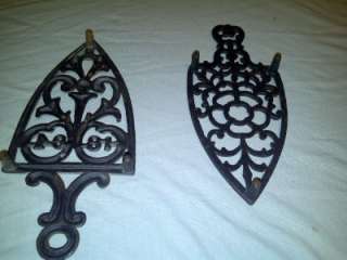 Lot of 2 Antique cast iron trivets one is dated 1894 3 legged  