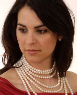 Woman wearing pearl stud clip earrings and a pearl necklace