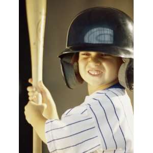  Boy in a Baseball Uniform Holding a Baseball Bat Premium 